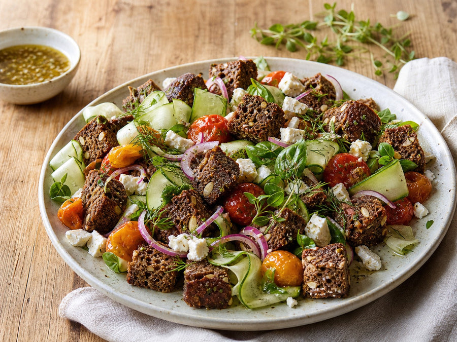 Saftkorn Kürbis-Mandel Brotsalat mit Tomaten, Gurke, Feta und gerösteten Brotwürfeln